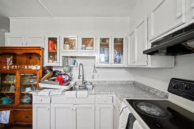 3917 Benton Blvd, Kansas City, MO 64130 - kitchen featuring electric stove, under cabinet range hood, white cabinets, and light countertops