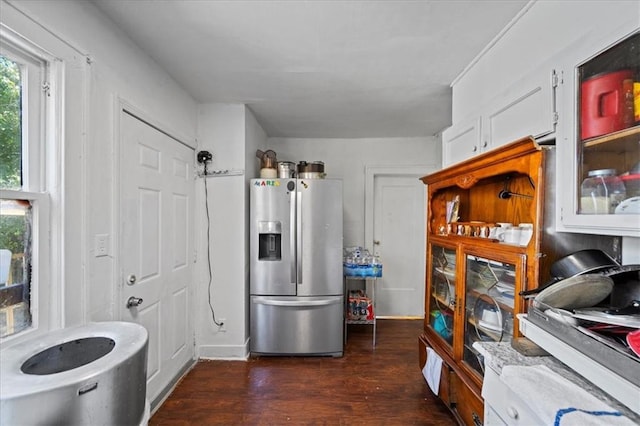 3917 Benton Blvd, Kansas City, MO 64130 - kitchen featuring stainless steel fridge, white cabinetry, dark wood-style flooring, and glass insert cabinets