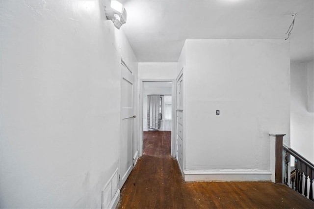 hallway with dark hardwood / wood-style flooring