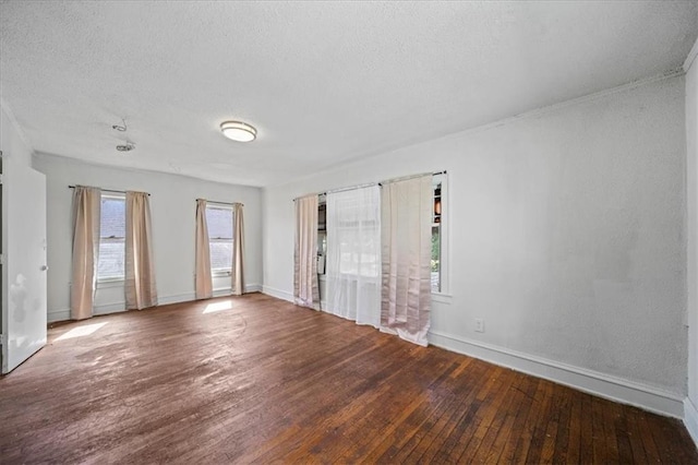 spare room featuring a textured ceiling and hardwood / wood-style floors