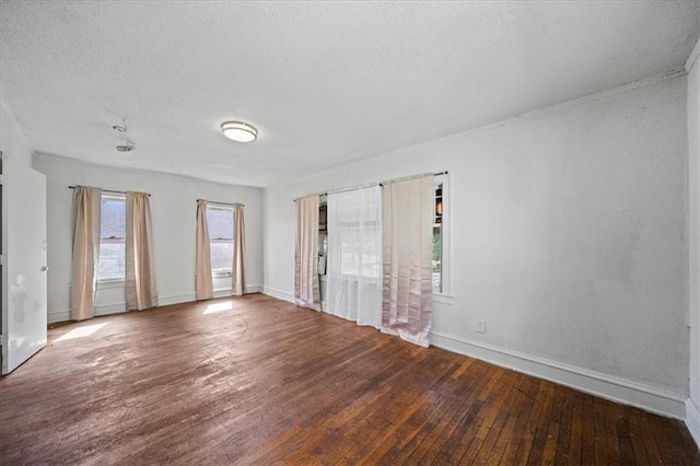 3917 Benton Blvd, Kansas City, MO 64130 - empty room featuring hardwood / wood-style floors, a textured ceiling, and baseboards