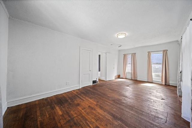 spare room with dark wood-type flooring