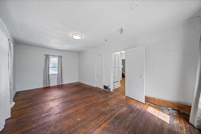 unfurnished room with dark hardwood / wood-style flooring