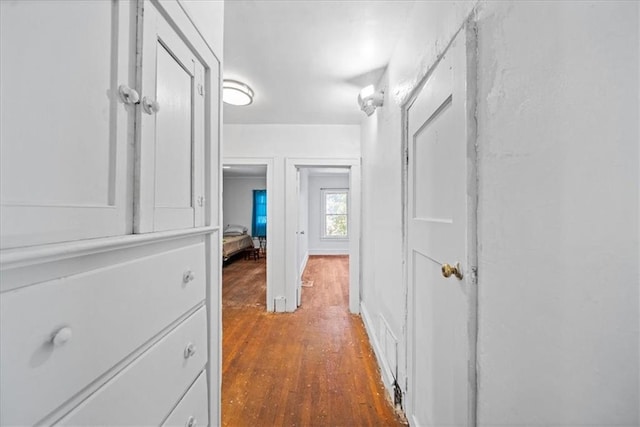 corridor with dark hardwood / wood-style flooring