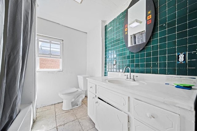 full bathroom featuring tile walls, shower / bath combo, vanity, and toilet