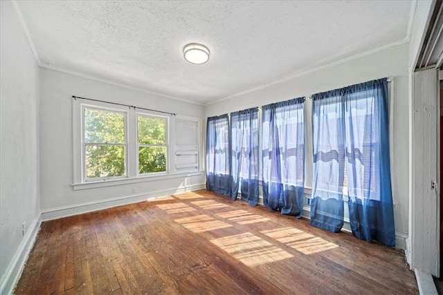 3917 Benton Blvd, Kansas City, MO 64130 - unfurnished room featuring hardwood / wood-style floors, ornamental molding, a textured ceiling, and baseboards