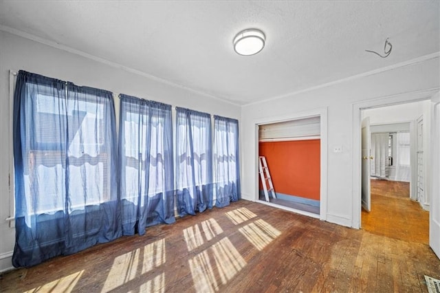 3917 Benton Blvd, Kansas City, MO 64130 - unfurnished room with ornamental molding, wood finished floors, and a textured ceiling
