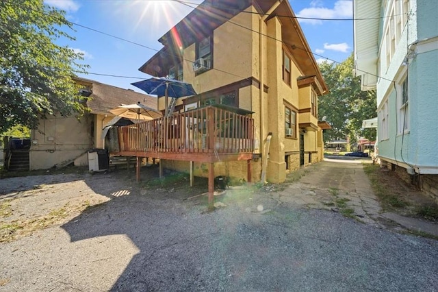 rear view of house featuring a deck