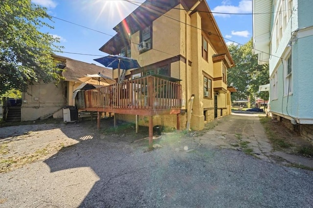 3917 Benton Blvd, Kansas City, MO 64130 - back of house with a deck and stucco siding