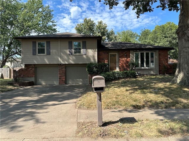 split level home with a front yard and a garage