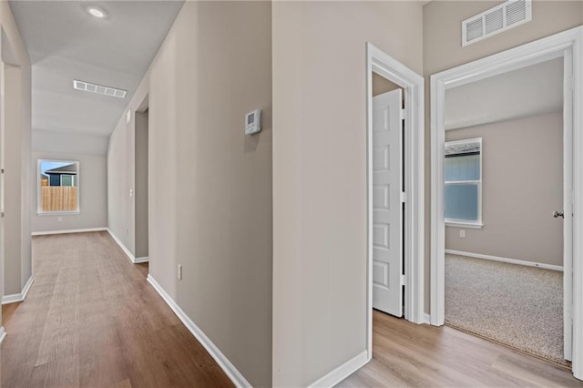 corridor with light hardwood / wood-style flooring