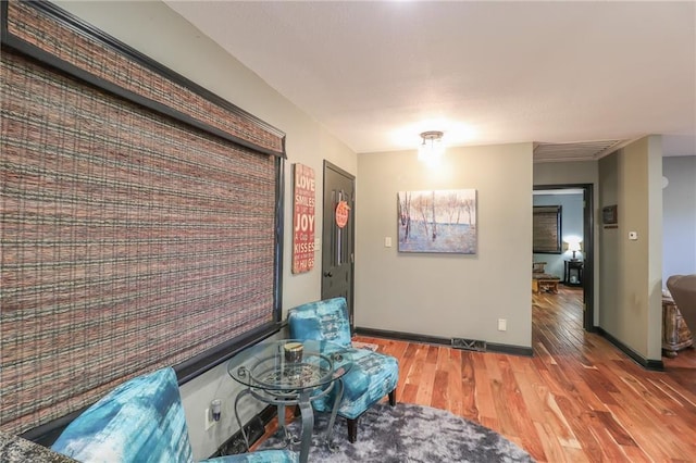 interior space featuring visible vents, baseboards, and wood finished floors