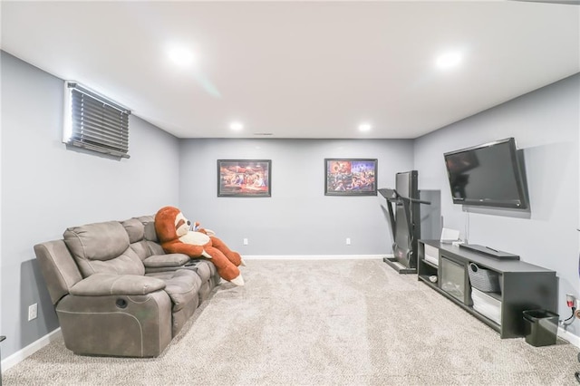 carpeted living area featuring baseboards and recessed lighting