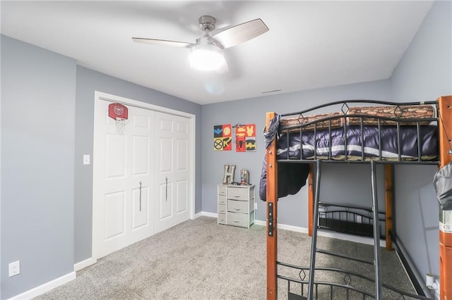 unfurnished bedroom with ceiling fan, carpet floors, visible vents, and baseboards