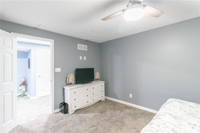 carpeted bedroom with a ceiling fan, visible vents, and baseboards