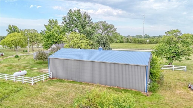 view of pole building featuring a yard and fence