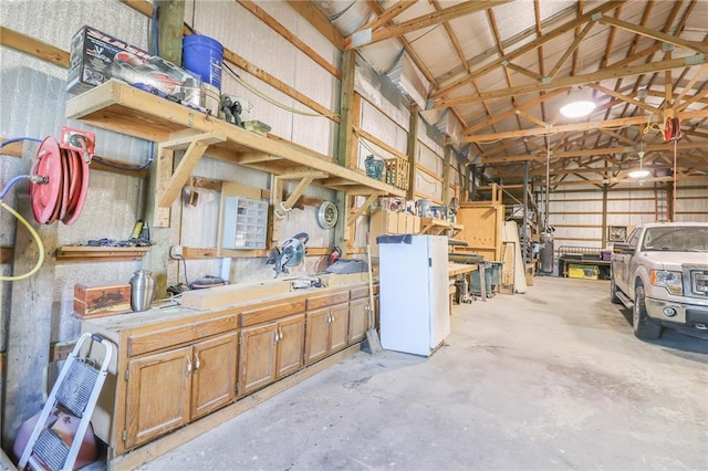 garage featuring metal wall and a workshop area