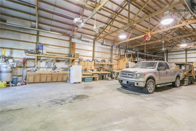 garage with a garage door opener, metal wall, and refrigerator