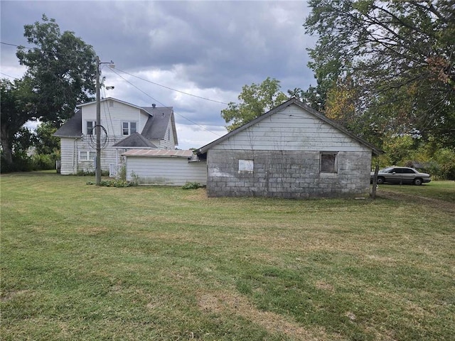 view of side of home featuring a lawn