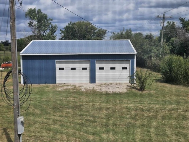 garage featuring a lawn