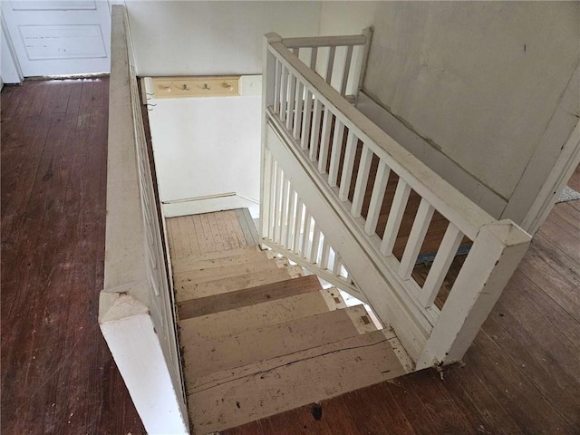 stairs featuring hardwood / wood-style floors