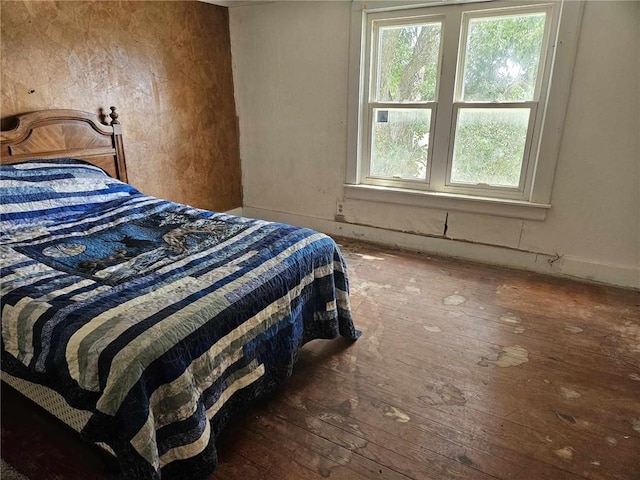 bedroom featuring multiple windows and hardwood / wood-style floors