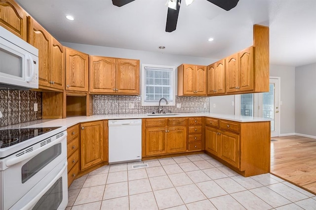 kitchen with white appliances, a healthy amount of sunlight, sink, and ceiling fan