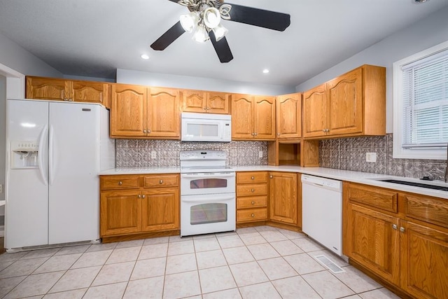 kitchen featuring white appliances, light tile patterned floors, sink, ceiling fan, and decorative backsplash