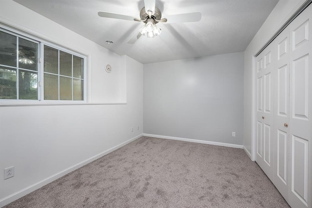 unfurnished bedroom featuring a closet, ceiling fan, and carpet floors