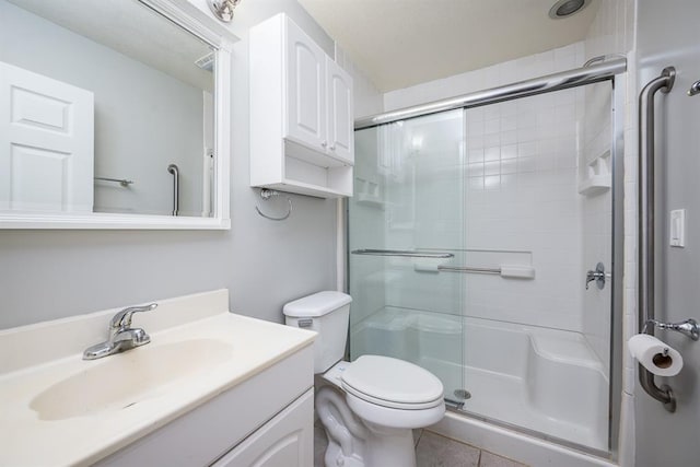 bathroom featuring tile patterned floors, walk in shower, toilet, and vanity