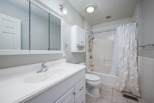 full bathroom featuring tile patterned floors, shower / bath combo, toilet, and vanity