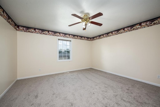 empty room featuring ceiling fan and carpet flooring