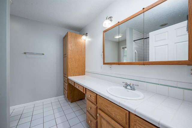 bathroom featuring vanity, a shower, and tile patterned floors