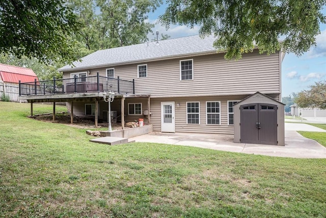 rear view of house with a patio area, a yard, central AC, a storage shed, and a wooden deck