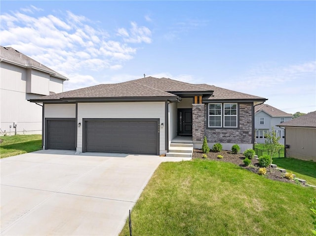 prairie-style home featuring a garage and a front lawn