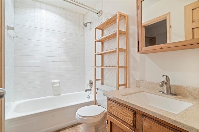 full bathroom with vanity, toilet, and tiled shower / bath