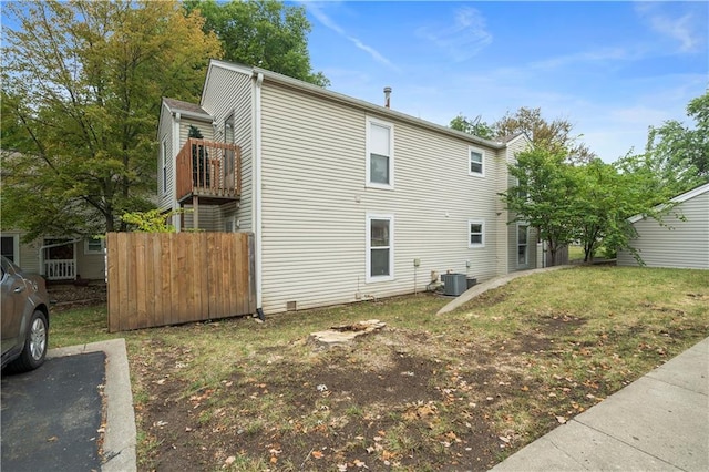 exterior space with a yard and central AC