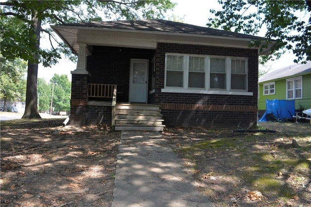 view of front of property featuring a porch and brick siding