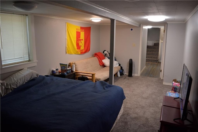 bedroom featuring carpet flooring, crown molding, and baseboards