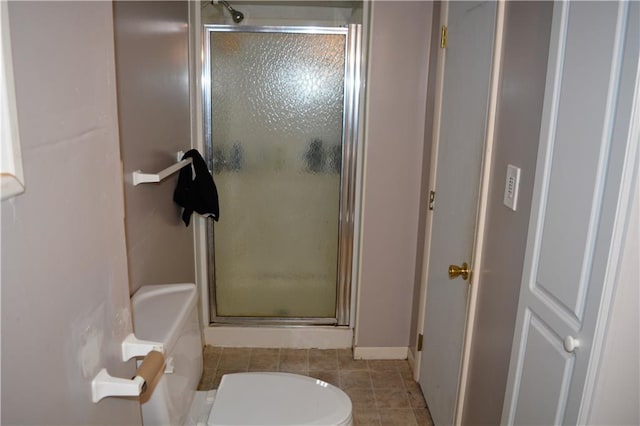 bathroom featuring plus walk in shower, toilet, and tile patterned floors