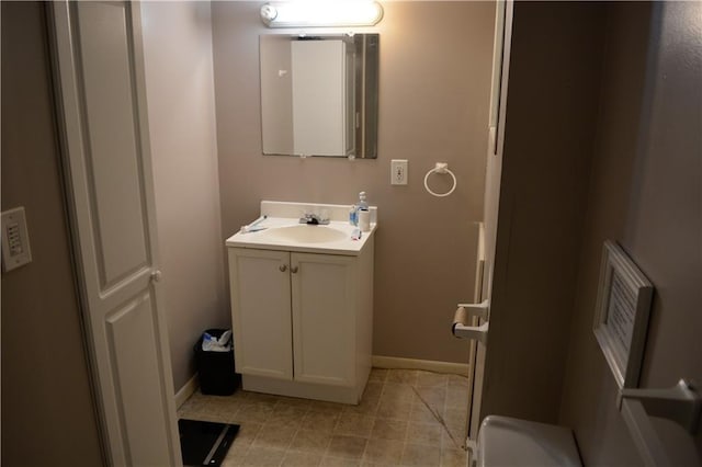 bathroom with vanity, baseboards, and tile patterned floors