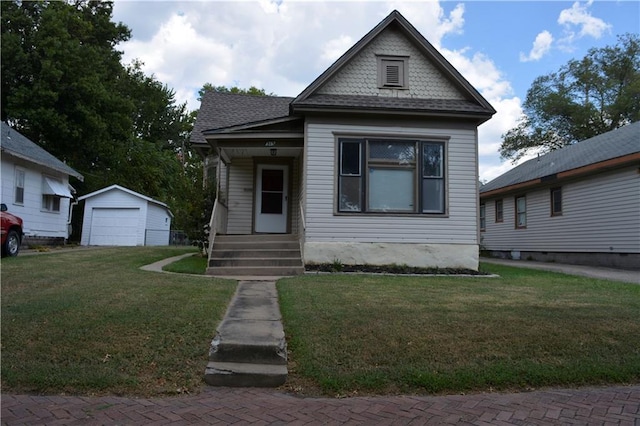 view of front of house with an outdoor structure, a garage, and a front lawn