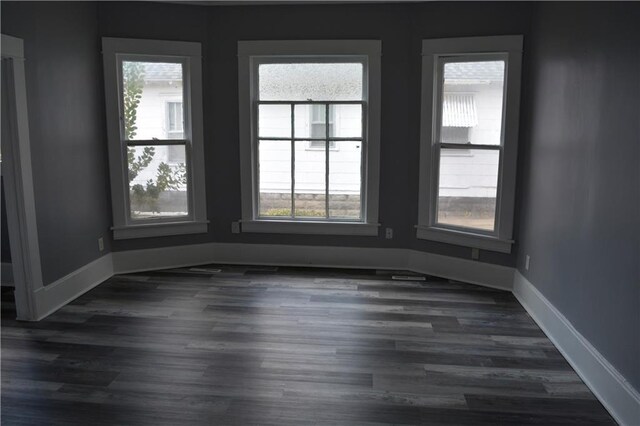 unfurnished room featuring dark hardwood / wood-style flooring