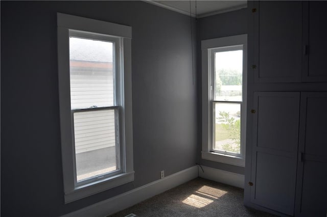 empty room featuring carpet flooring and baseboards