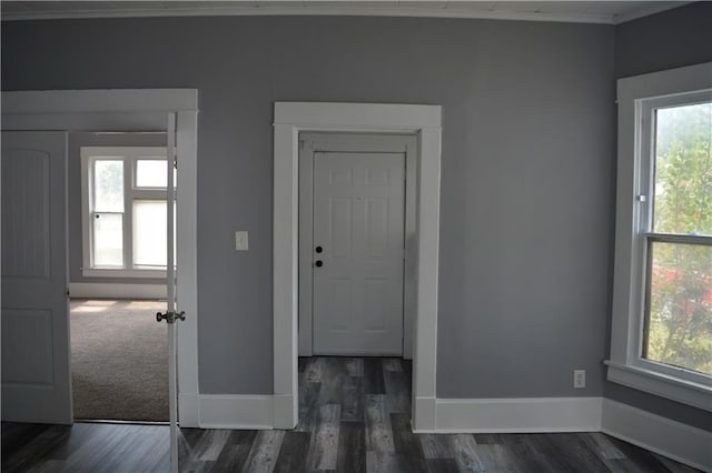 foyer featuring dark wood-type flooring and baseboards