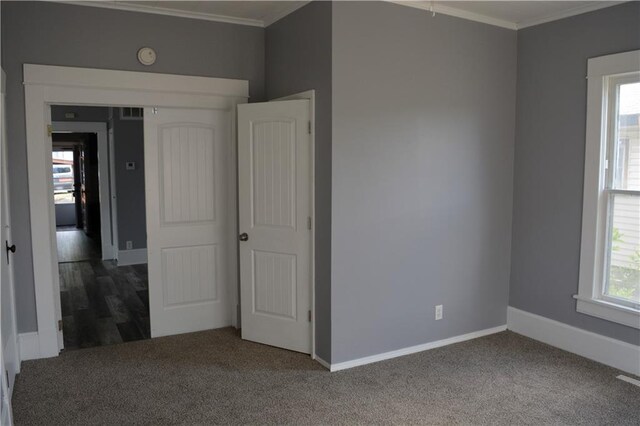 unfurnished bedroom with crown molding and carpet