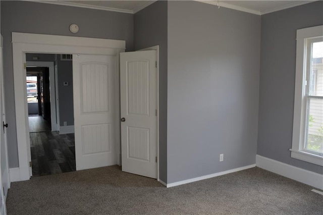 unfurnished bedroom featuring ornamental molding, carpet, and baseboards