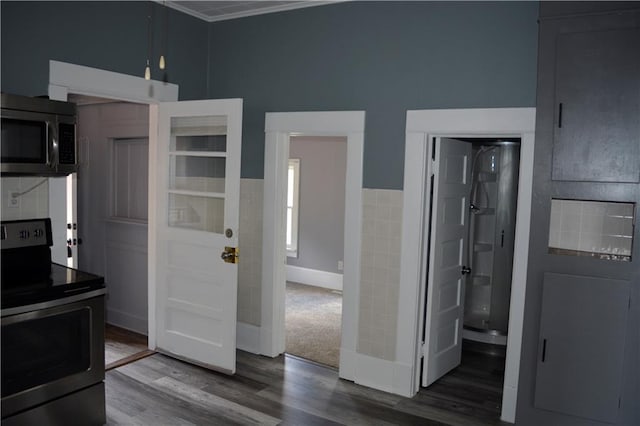 kitchen with wood finished floors and stainless steel electric stove