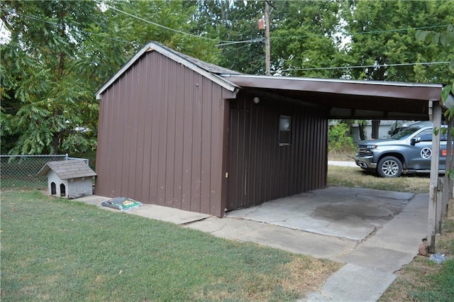 view of outbuilding featuring fence and an outdoor structure