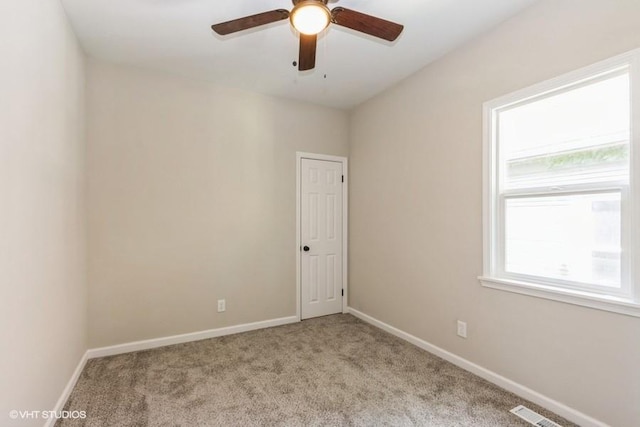 empty room with light carpet and ceiling fan